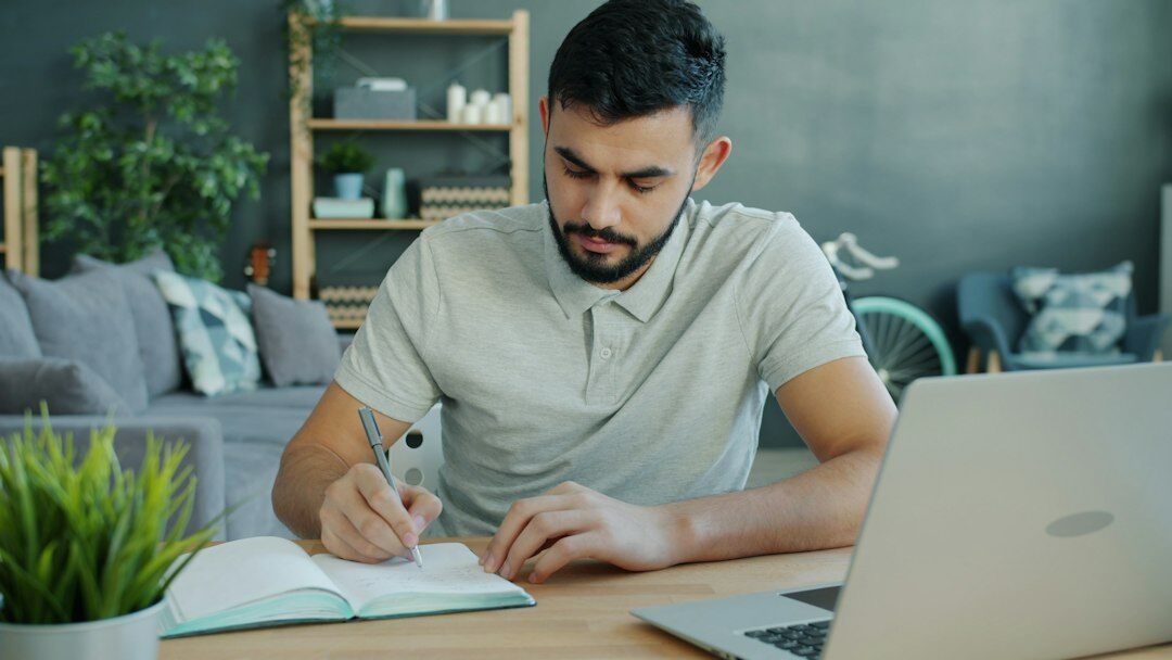 person writing in notebook